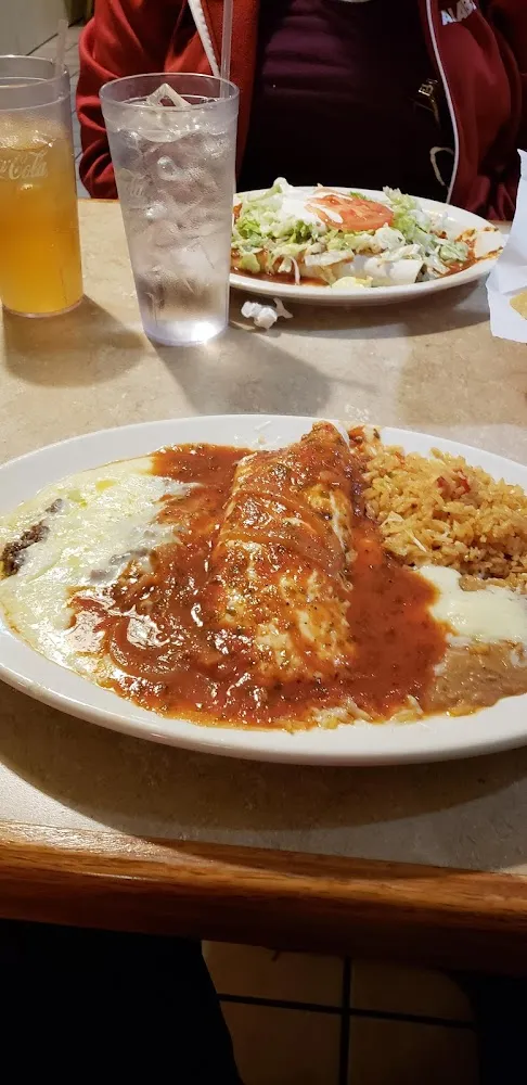 Enchiladas and Refried Beans with Mexican Cheese